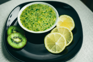 green smoothie with lemon and kiwi fruit on black plate

Код изображения:502961428