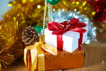 Gold Christmas background of de-focused lights with decorated tree