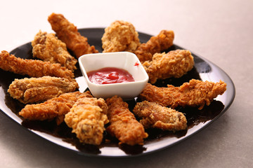 Grilled chicken on a plate standing the wooden table