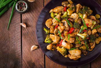 Stir fry with chicken, mushrooms, broccoli and peppers - Chinese food. Top view