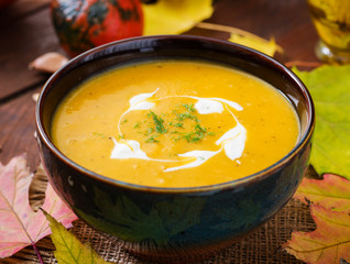 Cream of pumpkin soup with sour cream sauce. Halloween.