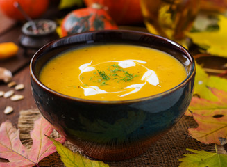 Cream of pumpkin soup with sour cream sauce. Halloween.