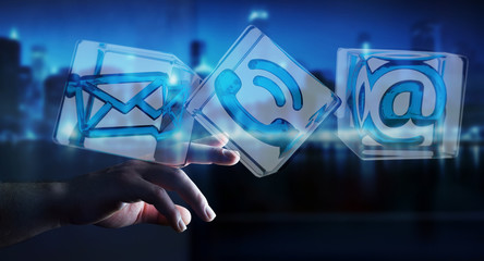 Businessman touching transparent cube contact icon with his fing