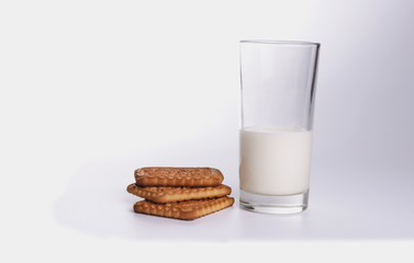 Splash of milk with various grain biscuits isolated on white