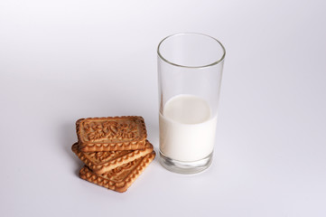 Splash of milk with various grain biscuits isolated on white
