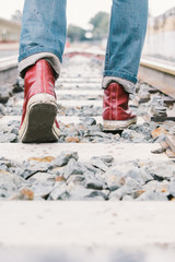 Traveller walking on railroad with vintage filter effect.