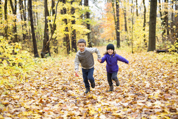 Happy children playing in beautiful autumn park