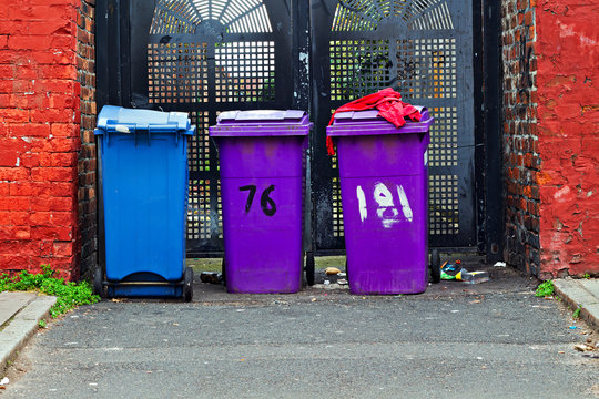 General waste and recyclable waste wheelie bins at the end of an alleyway in Liverpool UK