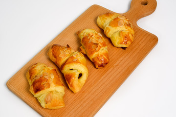 Delicious homemade croissants on a wooden tablet before breakfas