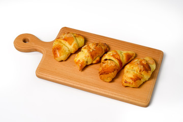 Delicious homemade croissants on a wooden tablet before breakfas