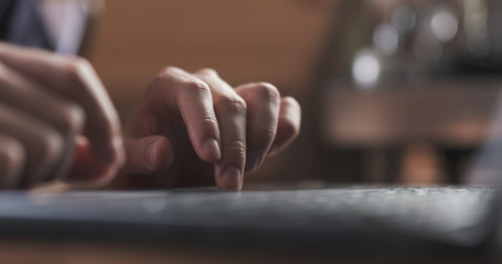 young man working on notebook in cafe or home hands closeup