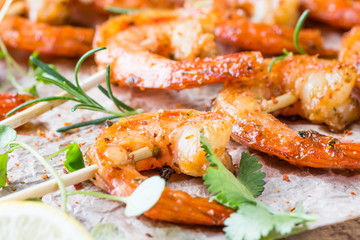 Grilled fried Shrimps Prawns on wooden skewers with spices