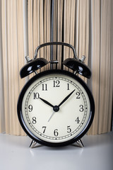 Open book and classic alarm clock