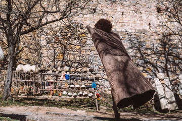 Georgian national costume hanging on wooden stick