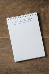 2017 resolutions list on notepad on wood table