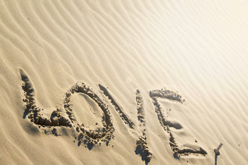 word love written on the beach