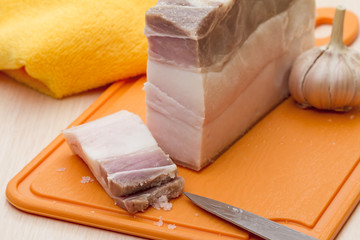 Salted bacon and garlic on a cutting board