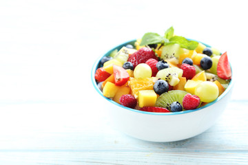 Fresh fruit salad on a white wooden table