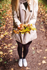 Autumn is here. Autumn is here. woman with colorful leaves in hands