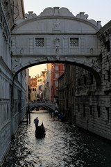 Gondolier rowing gondola before sunset on canal in Venice, Italy © Chatchai