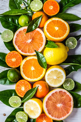 Assorted fresh citrus fruits with leaves. Background