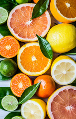 Assorted fresh citrus fruits with leaves. Background