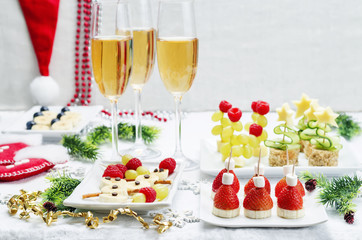 Assortment of New Year's snacks and a glass of champagne