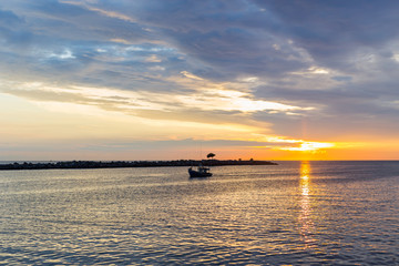 Fototapeta na wymiar Silhouette of Fishing Boat on Sunrise.
