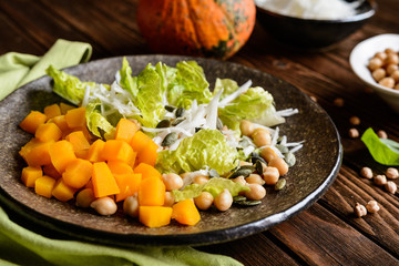 Pumpkin salad with chickpeas, radish, lettuce and seeds