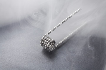 Tiger coil for vaping on a black background smoke