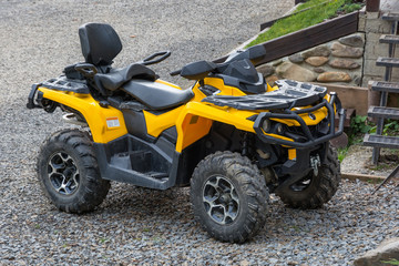 Yellow all-terrain vehicle. Yellow quadbike.