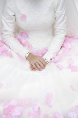 wedding dress and pink rose petals