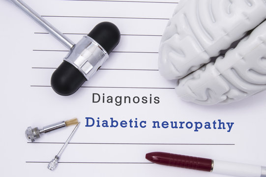 Diagnosis of Diabetic neuropathy. Neurological hammer and brain figure lie on a medical paper form with a heading diagnosis of Diabetic neuropathy on a table in the office of a neurologist