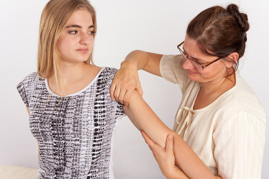 Young woman receives bowen therapy for her arm
