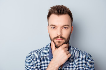 Portrait of serious minded businessman isolated on gray backgrou
