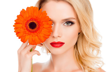 Sensual sexy blonde holding flower near her eye