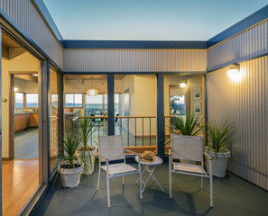 Fototapeta premium Sliding doors within open Courtyard at twilight. 