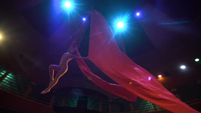 woman dancer on aerial silk, aerial contortion, Slow motion
