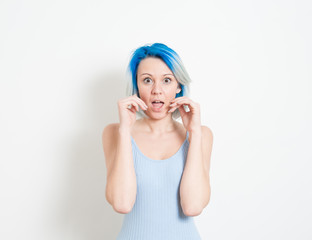 Stunned young alternative teenager woman on white portrait