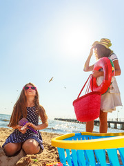 Mother and daughter playing on beach.