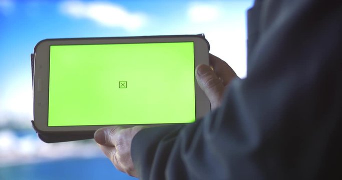 Ipad Tablet PC with Green Screen city background