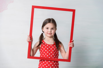 little girl in red with red painting frame
