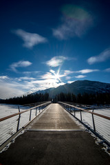 Bridge in winter with mountain and blue sky