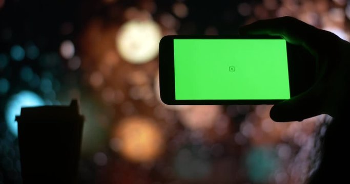 smartphone with Green Screen city night bokeh background