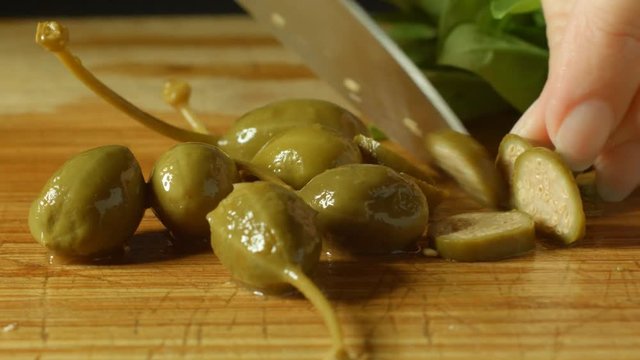 healthy fresh green caperberries cutting up in kitchen