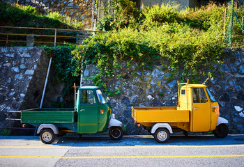 Two Piaggio Ape trikes / Green and yellow mini cars