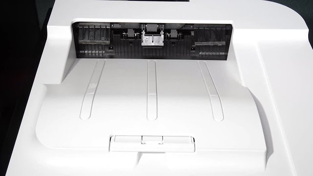 An office laser jet printer prints a single page for proof reading.