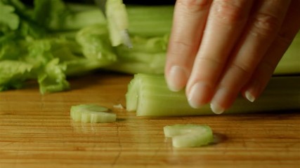 healthy fresh celery food prep cutting up of vegetables and fruit in kitchen