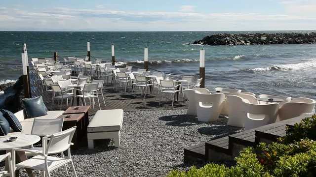 External Cafe terrace on the beach with table and chairs.Cafe is located in Greece in Platamonas.