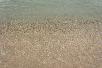 Stone,sand,shell sea water and beach with lighting in the morning